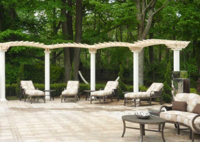 Custom Made Landscape Pergolas Provide Shade Above Outdoor Furniture in a Luxurious Backyard Oasis